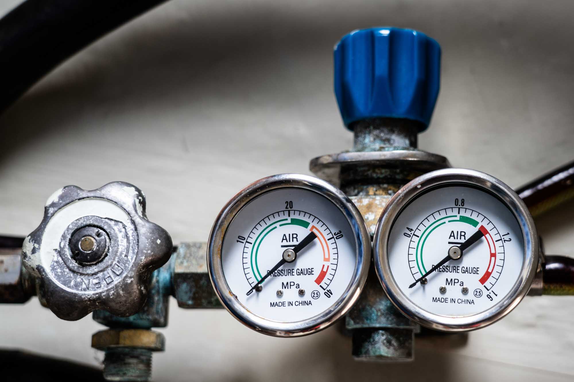 Close-up of two air pressure gauges and dials on metal equipment, showing measurements in MPa.