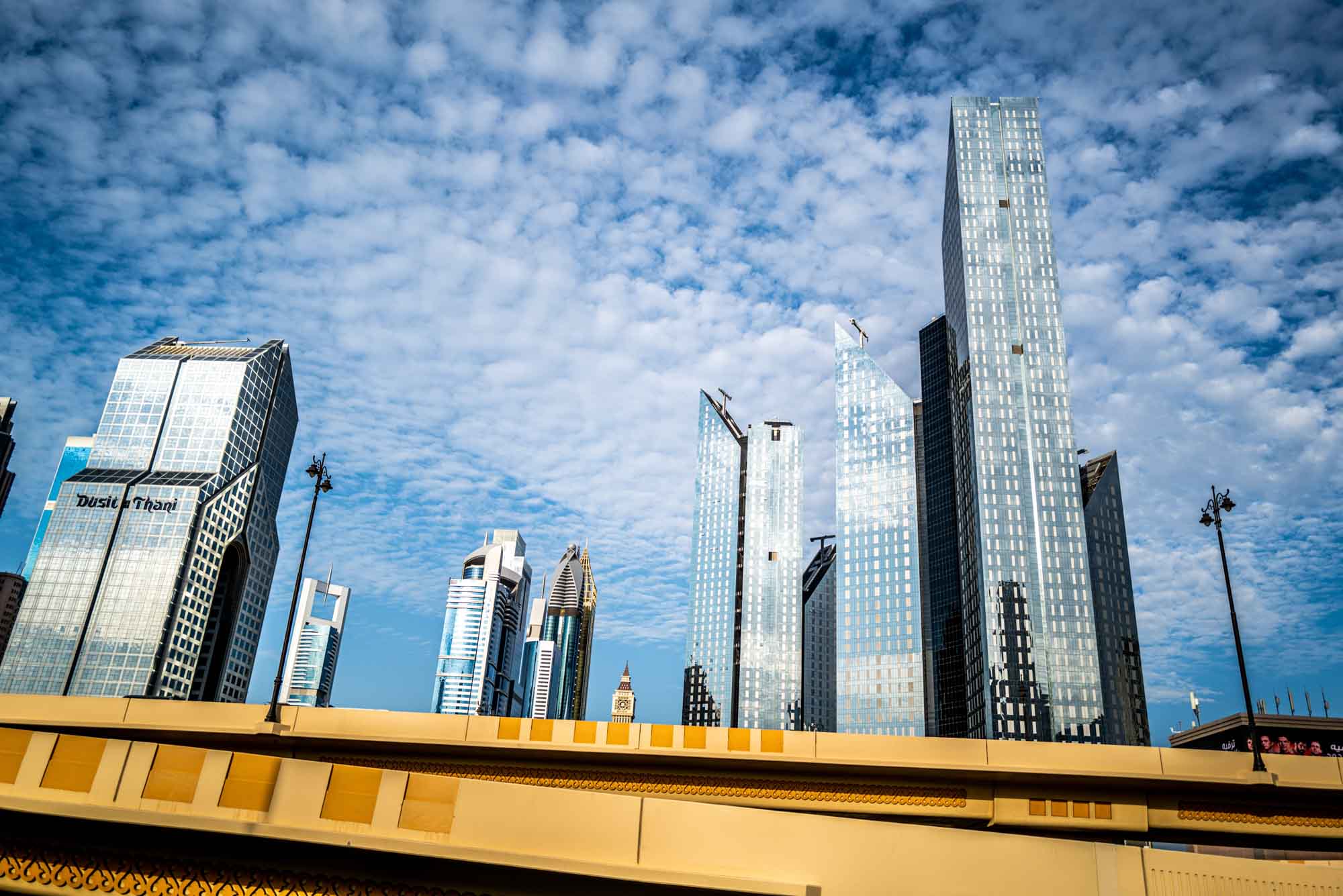 Skyscrapers against a cloudy sky in a modern city skyline.