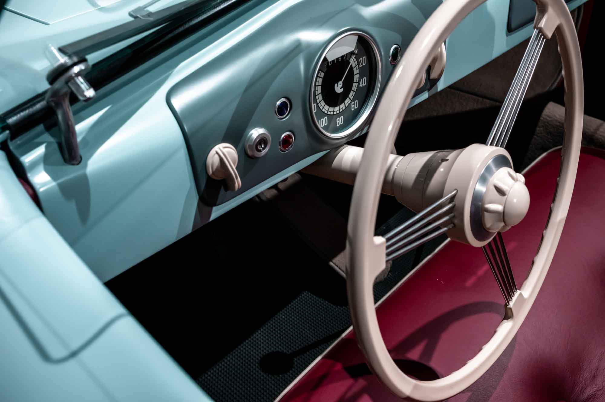 Vintage car interior, steering wheel and dashboard display classic design with retro speedometer.