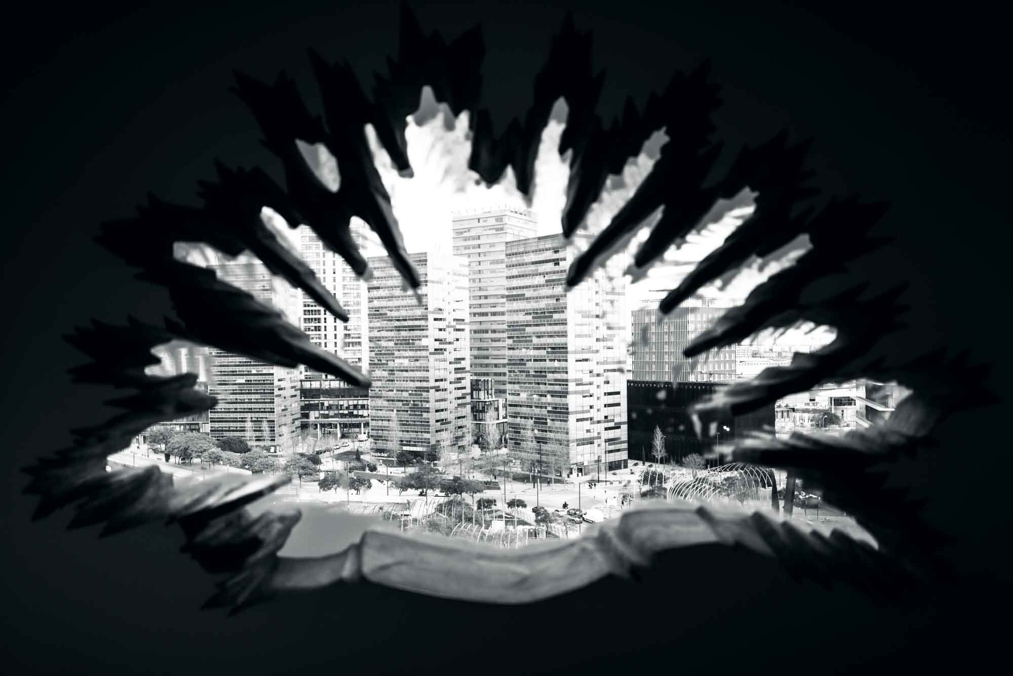 Abstract black and white urban skyline framed by jagged, dark shapes.