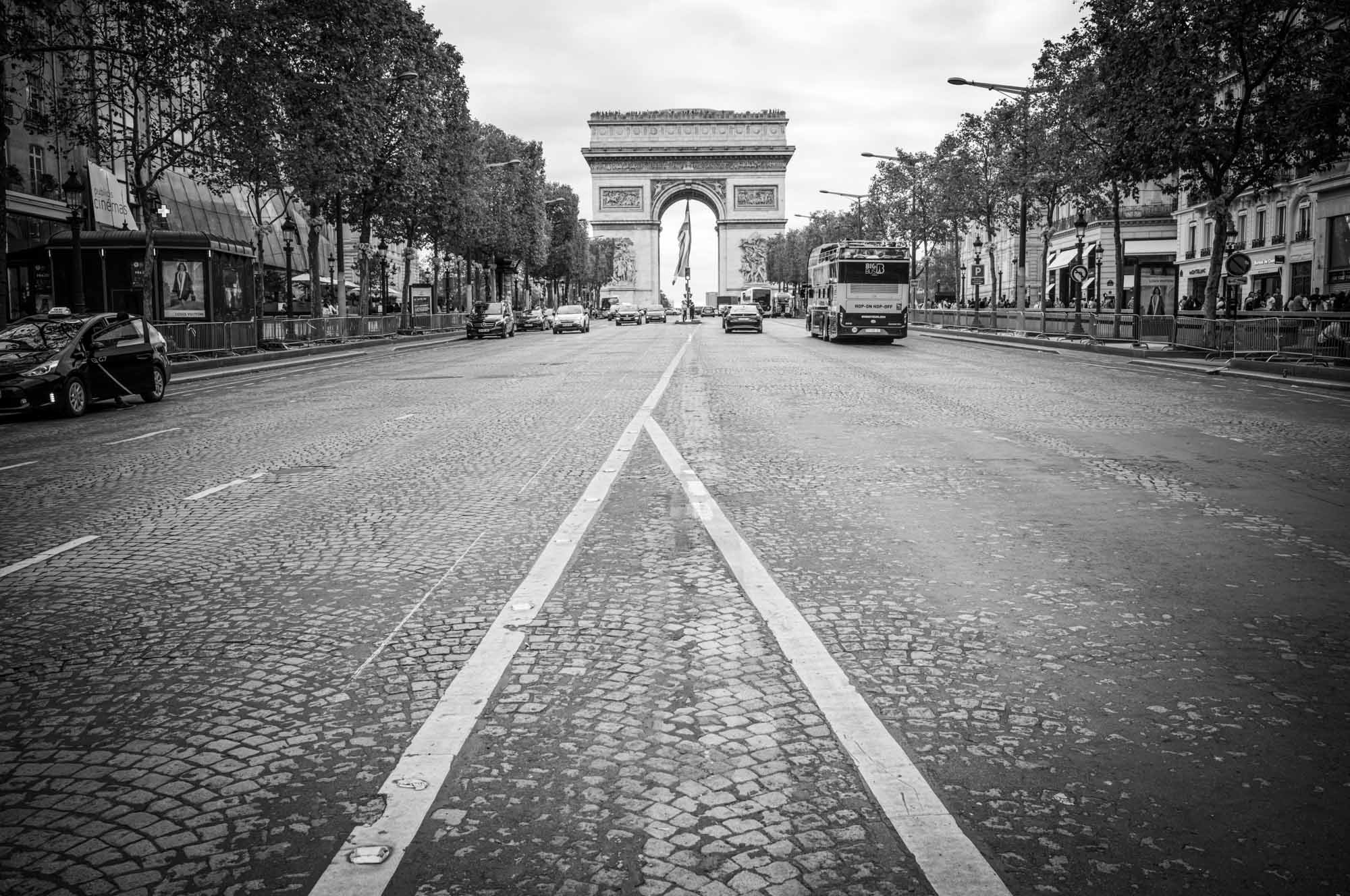 Black and white photo of the Arc de Triomphe, Paris, with a view down the Champs-Élysées.