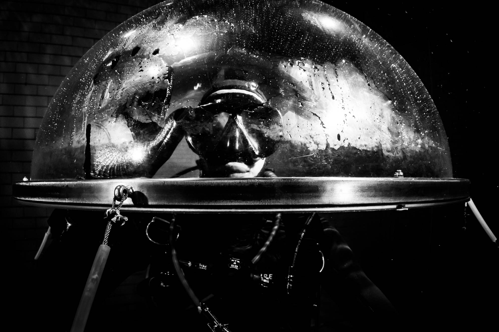 Diver in vintage helmet, black and white photo, underwater exploration theme.