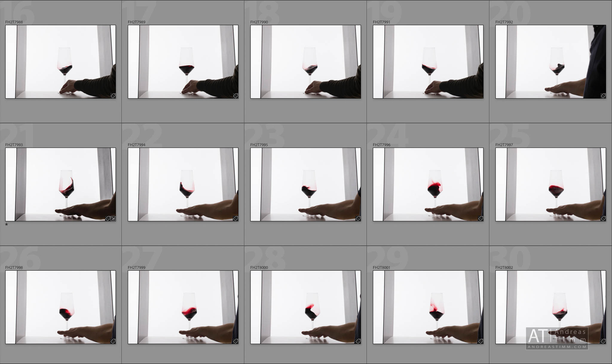 Sequence of a wine glass being swirled by a hand against a bright background.