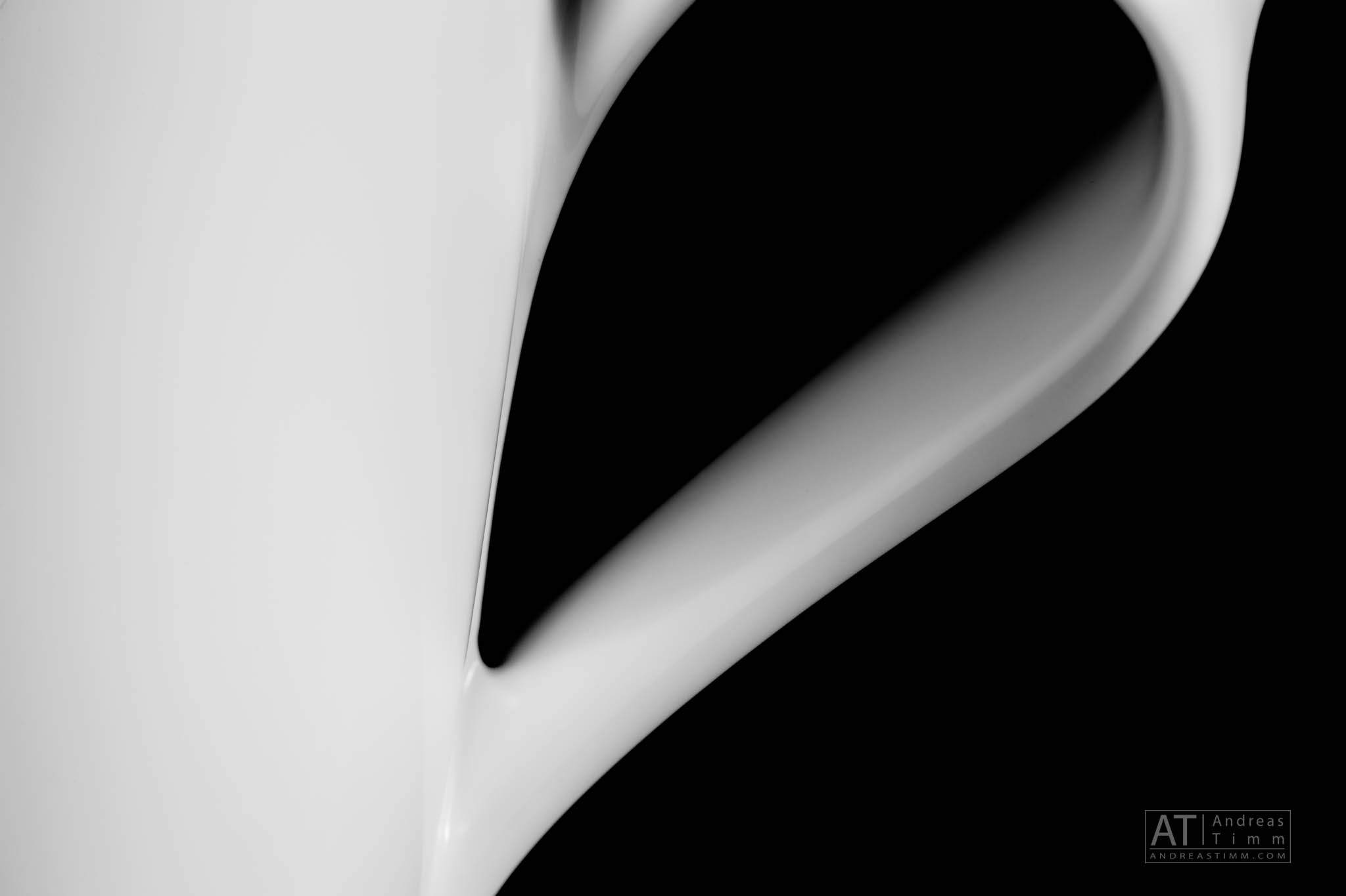 Abstract close-up of white and black curved shapes in minimalistic design.
