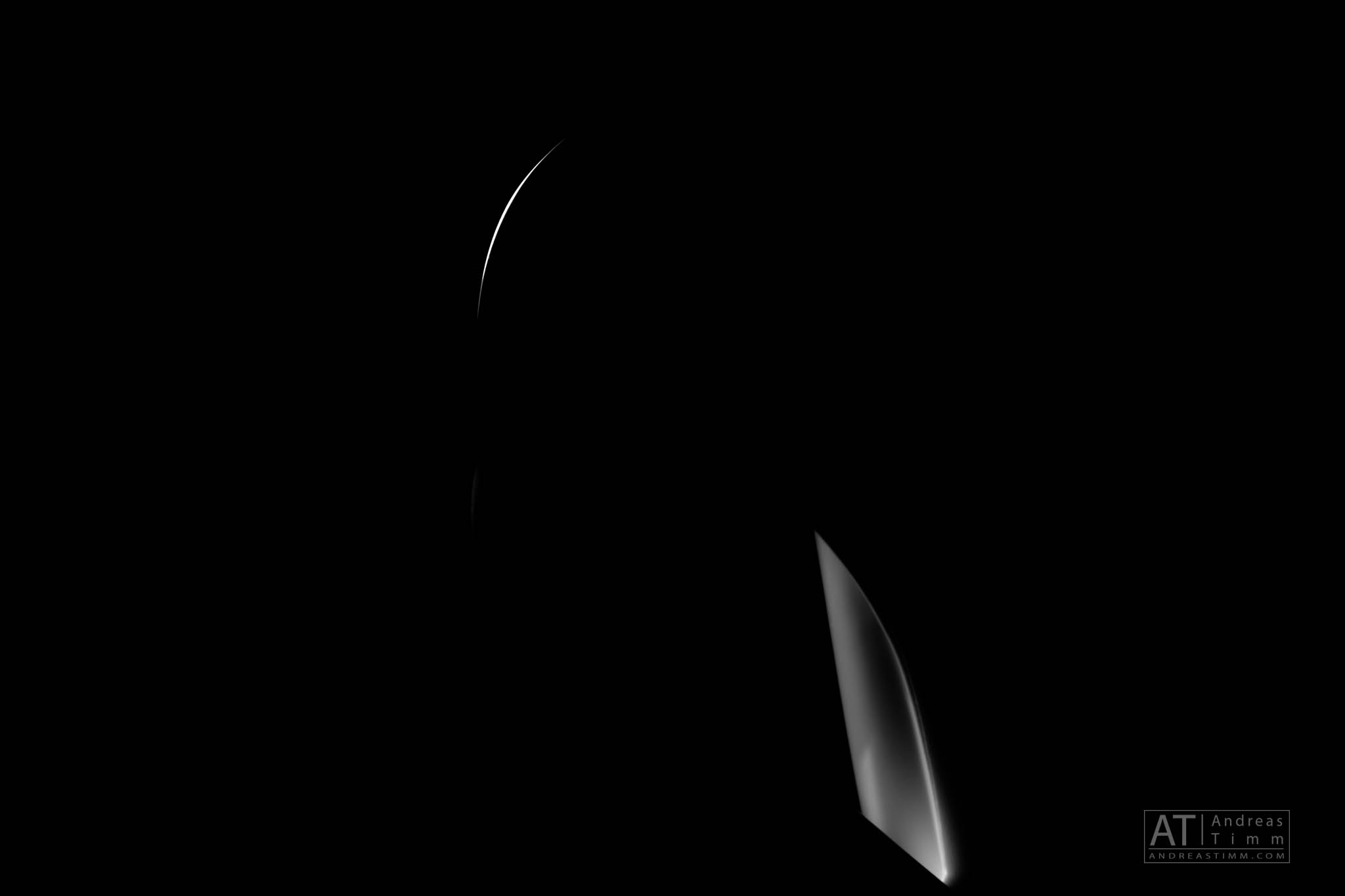 Mysterious abstract image with curved highlights on a dark background.