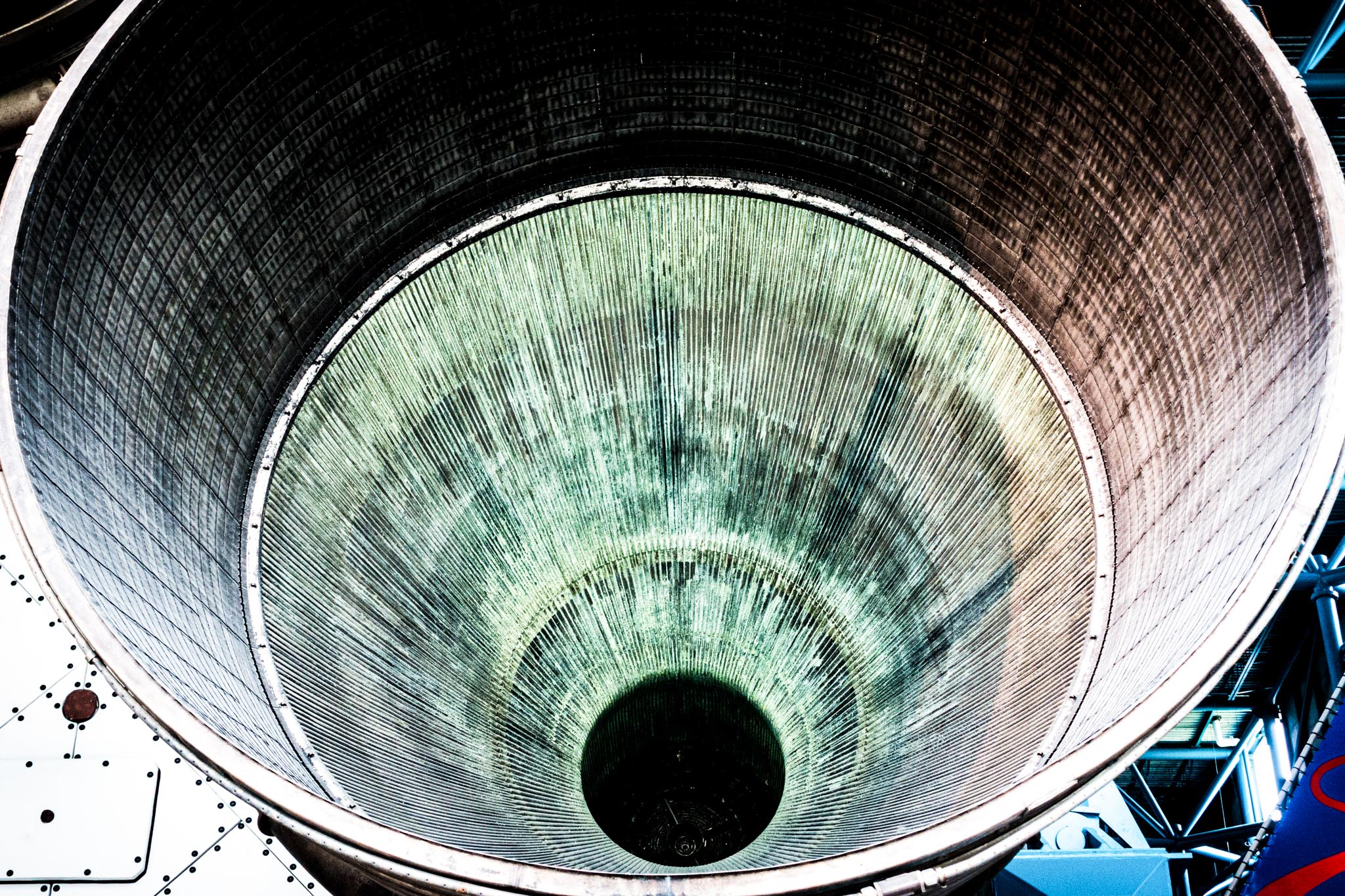 Close-up of a large, circular rocket nozzle showing textured metal interior, capturing industrial design details.