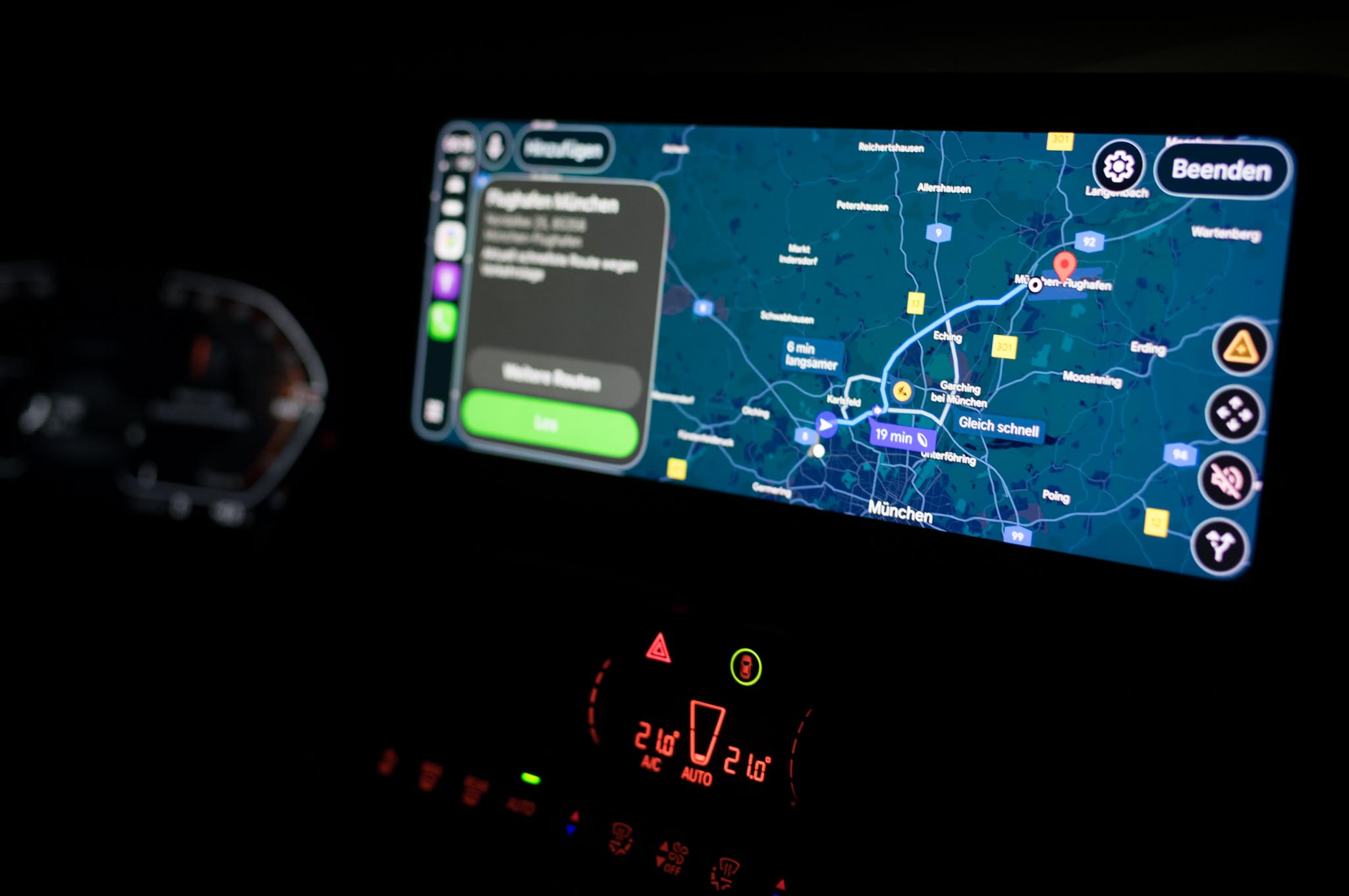 Car navigation screen showing map of Munich with routes highlighted.
