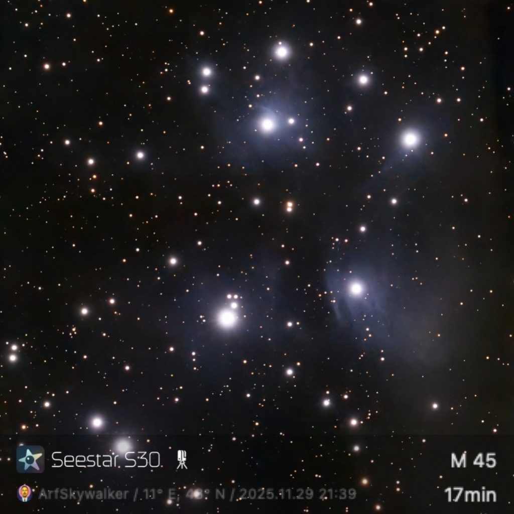 Bright night sky capturing the Pleiades star cluster, M45, with numerous glowing stars against a dark backdrop.