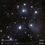Bright night sky capturing the Pleiades star cluster, M45, with numerous glowing stars against a dark backdrop.