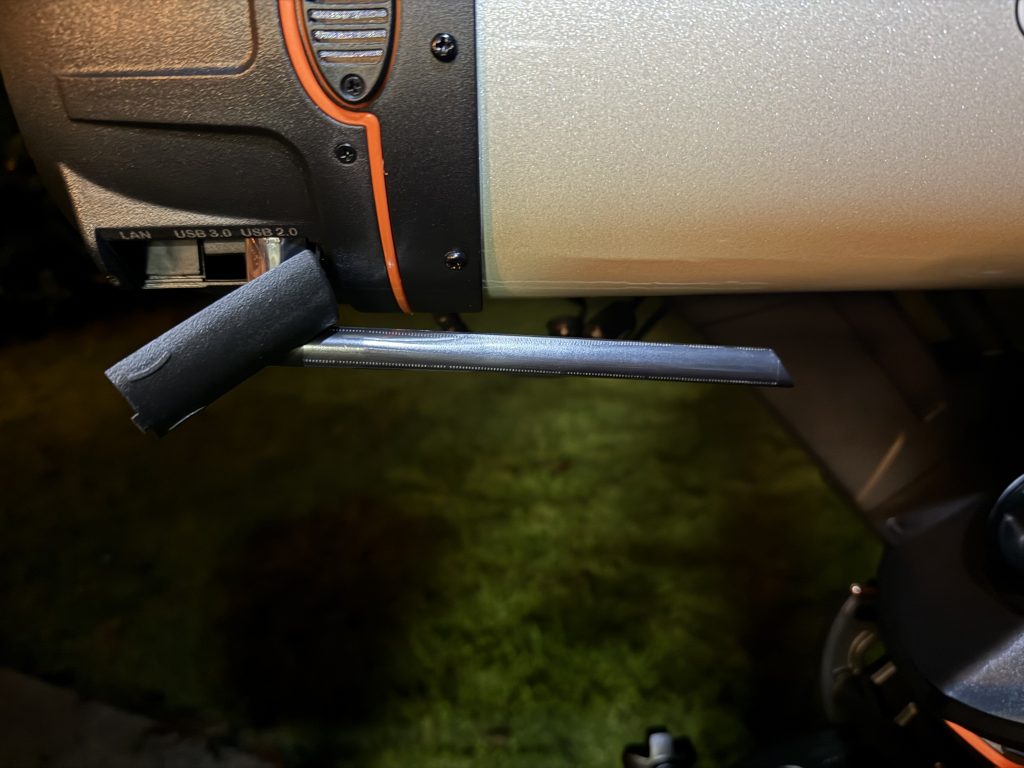 Close-up of a telescope support bar with wrapped cables, highlighting USB 3.0 and LAN ports in a nighttime setting.